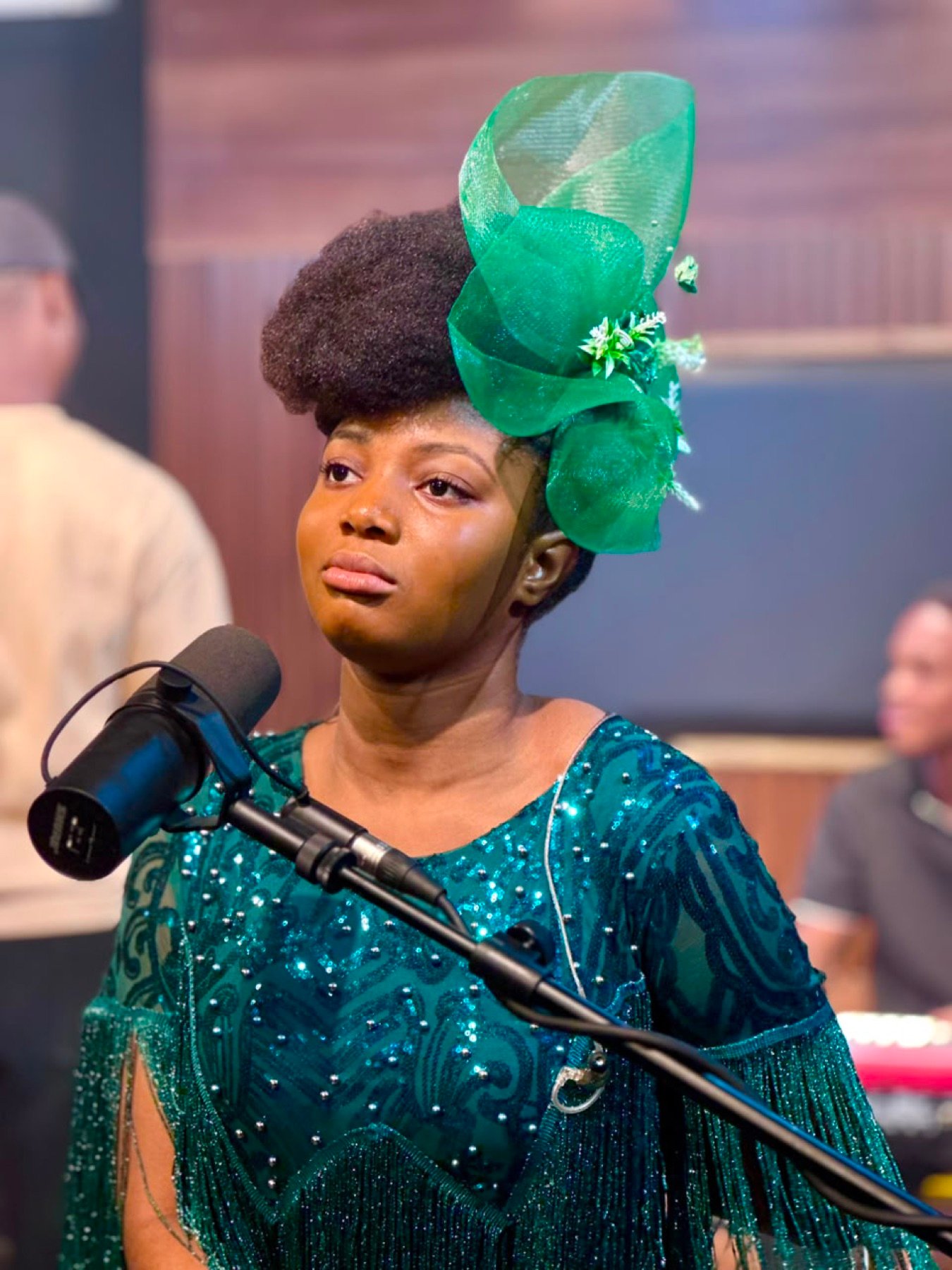 Emily Adade Boateng singing at a studio microphone